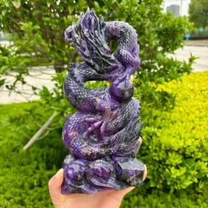 Handmade purple charoite dragon carving with a curling tail and detailed scales